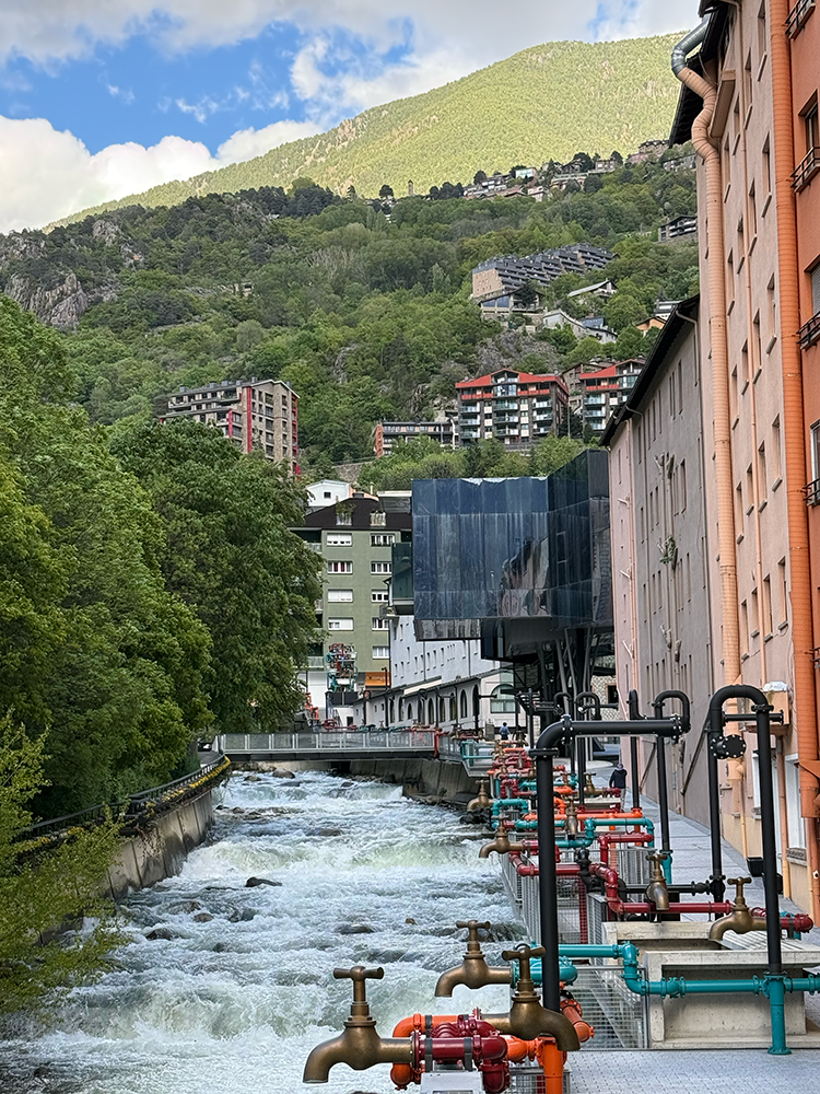 Street in Andorra along the river lined with pipes